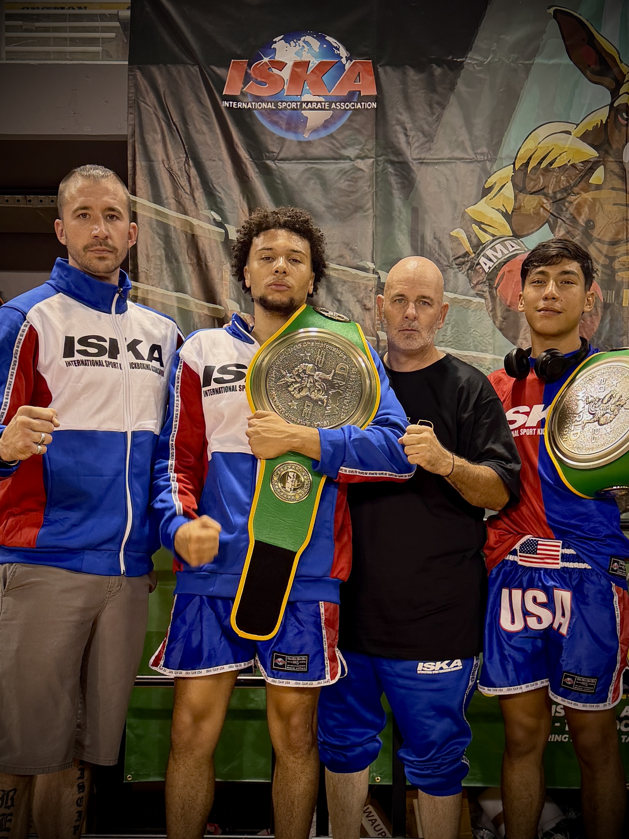 Josh Thomas with team and championship belts